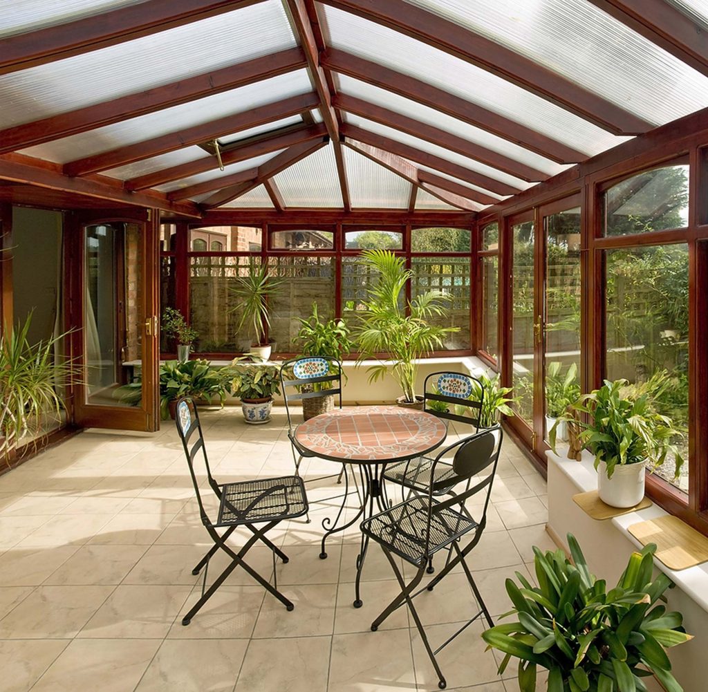 Sunroom with tiled floor, plants, and patio furniture 
