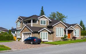 Luxury residential house double garage and car parked on paved driveway