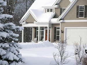 View of a snow-covered home with energy efficiency windows 