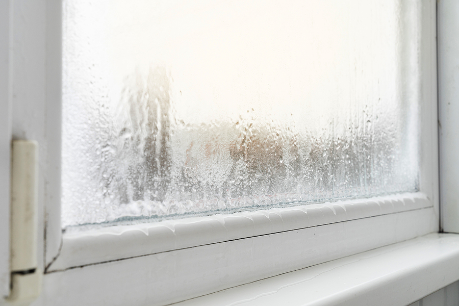 Close up of a window with condensation and freezing inside. 