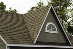 New asphalt shingles on a forest green home's roof