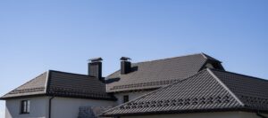 Roofing on a suburban home with chimneys