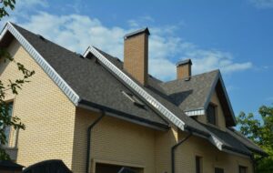Asphalt shingle roofing on a tan home