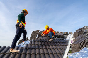 Two workers installing a roof