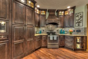 Kitchen with wooden cabinets and granite backsplash